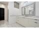 Bright bathroom with a double sink vanity, large mirror, and marble countertops and backsplash at 9280 E Thompson Peak Pkwy # 39, Scottsdale, AZ 85255