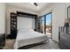 Guest bedroom with built-in shelving, a murphy bed, and patio access at 9280 E Thompson Peak Pkwy # 39, Scottsdale, AZ 85255