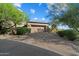 Spacious garage and driveway surrounded by lush desert landscaping at 9280 E Thompson Peak Pkwy # 39, Scottsdale, AZ 85255