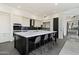 Bright kitchen featuring a spacious island with bar seating, sleek finishes, and stainless steel appliances at 9280 E Thompson Peak Pkwy # 39, Scottsdale, AZ 85255