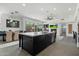 Modern kitchen featuring a large island, stainless steel appliances, and an open floor plan to the living area at 9280 E Thompson Peak Pkwy # 39, Scottsdale, AZ 85255