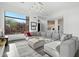 Bright living room featuring a sectional sofa, gray rug and light fixture at 9280 E Thompson Peak Pkwy # 39, Scottsdale, AZ 85255