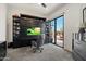 Office with custom cabinets, a built-in desk, and sliding glass doors to patio at 9280 E Thompson Peak Pkwy # 39, Scottsdale, AZ 85255
