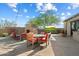 Inviting outdoor seating area with fireplace, TV, lush landscaping and string lights at 9280 E Thompson Peak Pkwy # 39, Scottsdale, AZ 85255