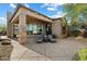 Stylish covered patio with lounge chairs, stone columns, and scenic backyard views at 9280 E Thompson Peak Pkwy # 39, Scottsdale, AZ 85255
