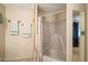 Bathroom featuring a shower-tub combination, mirror, and towel rack at 9347 E Edgewood Ave, Mesa, AZ 85208