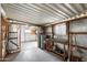 Spacious garage featuring shelving, work bench, and water heater at 9347 E Edgewood Ave, Mesa, AZ 85208