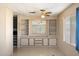 Bright living room showcasing built-in cabinets and classic ceiling fan at 9347 E Edgewood Ave, Mesa, AZ 85208