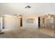 Spacious living room featuring a ceiling fan and built-in shelving at 9347 E Edgewood Ave, Mesa, AZ 85208