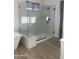 Modern bathroom with a glass-enclosed shower, standalone tub, and sleek fixtures at 1185 E Gleneagle Dr, Chandler, AZ 85249