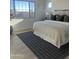 Bright bedroom with a large window and a comfortable bed dressed in neutral tones, complemented by a rug at 1185 E Gleneagle Dr, Chandler, AZ 85249
