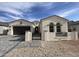 Charming single-story home with a two-car garage, stone driveway, and beautiful wrought-iron gate at 1185 E Gleneagle Dr, Chandler, AZ 85249