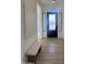 Entryway featuring a minimalist bench, sleek black door with sidelights, and modern art at 1185 E Gleneagle Dr, Chandler, AZ 85249