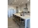 Bright kitchen featuring a large island with barstool seating, white cabinets, and stainless steel appliances at 1185 E Gleneagle Dr, Chandler, AZ 85249