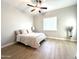 Bright bedroom features a ceiling fan, wood-look floors and a large window at 11934 S 181St Ave, Goodyear, AZ 85338