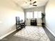 Bright office features a ceiling fan, neutral walls and a decorative rug at 11934 S 181St Ave, Goodyear, AZ 85338
