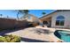 Home's outdoor living space featuring a brick patio, desert landscaping, pool at 14748 W Willow Ln, Surprise, AZ 85374