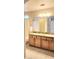 Bathroom with granite countertops and dual sinks at 14748 W Willow Ln, Surprise, AZ 85374