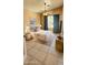 Inviting bedroom features a plush bed, soft lighting, and tiled floors at 14748 W Willow Ln, Surprise, AZ 85374