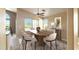 Dining room with table and six chairs, neutral tones, and a view of the backyard and pool at 14748 W Willow Ln, Surprise, AZ 85374