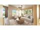 Bright living room features neutral tones, modern furnishings, and an inviting open layout overlooking the pool at 14748 W Willow Ln, Surprise, AZ 85374