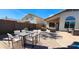 Outdoor patio area for entertaining, with comfortable seating and a dining table at 14748 W Willow Ln, Surprise, AZ 85374