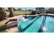 In-ground pool with stone waterfall feature and desert landscaping at 14748 W Willow Ln, Surprise, AZ 85374