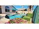 Private in-ground pool with covered patio and desert landscaping at 14748 W Willow Ln, Surprise, AZ 85374