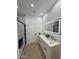 Modern bathroom featuring a double vanity, LED mirror, and luxurious marble shower at 15864 S Cherry Hills Dr, Arizona City, AZ 85123