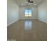Spacious bedroom featuring tile floors and a window view at 15864 S Cherry Hills Dr, Arizona City, AZ 85123