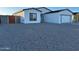 Charming single-story home featuring a white exterior, black trim, and a well-maintained gravel front yard at 15864 S Cherry Hills Dr, Arizona City, AZ 85123