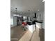 Bright kitchen with white cabinets, black countertops, island with seating, and stainless steel appliances at 15864 S Cherry Hills Dr, Arizona City, AZ 85123