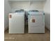 Well-lit laundry room with new washer and dryer on tile floor at 15864 S Cherry Hills Dr, Arizona City, AZ 85123