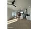 Bright open-concept living space featuring tile floors, modern light fixtures, and a kitchen island with seating at 15864 S Cherry Hills Dr, Arizona City, AZ 85123