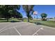 Community basketball court with benches, mature trees, and grassy area for recreation and neighborhood fun at 1846 E Intrepid Ave, Mesa, AZ 85204
