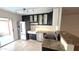 Modern kitchen with stainless steel appliances, black cabinets, granite countertops, and tile flooring at 1846 E Intrepid Ave, Mesa, AZ 85204