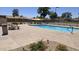 Inviting community pool area with picnic tables and sunshade structure at 1846 E Intrepid Ave, Mesa, AZ 85204