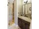 Bathroom features a glass door shower, dark wood cabinets and a marble countertop at 20084 N 103Rd St, Scottsdale, AZ 85255