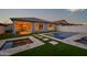 An inviting backyard features a pool, spa, and travertine decking with synthetic grass accents, perfect for entertaining at 22849 E Marsh Rd, Queen Creek, AZ 85142