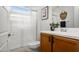 A well-lit bathroom with a vanity and sink, accompanied by a shower with glass doors at 22849 E Marsh Rd, Queen Creek, AZ 85142