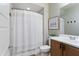 A bathroom featuring shower with curtain, wood vanity, light walls, and towel hooks on the walls at 22849 E Marsh Rd, Queen Creek, AZ 85142