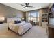This primary bedroom offers a ceiling fan, sitting area and is lit with bright natural light at 22849 E Marsh Rd, Queen Creek, AZ 85142