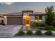 Charming home exterior with a well-manicured landscape, a welcoming front door, and warm exterior lighting at 22849 E Marsh Rd, Queen Creek, AZ 85142