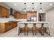 Stylish kitchen featuring stainless steel appliances, a large island with seating, and sleek countertops at 22849 E Marsh Rd, Queen Creek, AZ 85142
