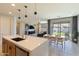 Open-concept kitchen flows to the living and dining area, with backyard views through sliding glass doors at 22849 E Marsh Rd, Queen Creek, AZ 85142