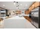 Modern kitchen boasts stainless steel appliances, a spacious island, and beautiful cabinetry with ample counter space at 22849 E Marsh Rd, Queen Creek, AZ 85142