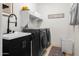 This modern laundry room offers appliances, storage, countertop, and a sink at 22849 E Marsh Rd, Queen Creek, AZ 85142