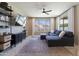 Inviting living room features a comfortable sectional sofa, ceiling fan, and media center with stylish shelving at 22849 E Marsh Rd, Queen Creek, AZ 85142