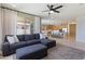 Open-concept living room with a large sectional sofa flows into a kitchen with an island and bar stool seating at 22849 E Marsh Rd, Queen Creek, AZ 85142