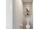 A stylish powder room showcasing modern geometric wallpaper, a floating shelf, and a sleek toilet at 22849 E Marsh Rd, Queen Creek, AZ 85142